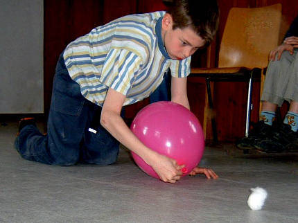inflate a balloon and use it to move a cotton ball