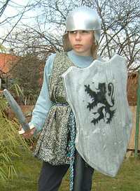 Chain shirt from an old carnival costume (glitter costume),Helmet made from an old plastic ball with jute material sewn on as a protection peak, Wooden shield and wooden sword.