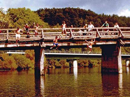 Jump into cold water under a bridge