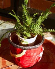 A patterned flower pot covered with paper mache